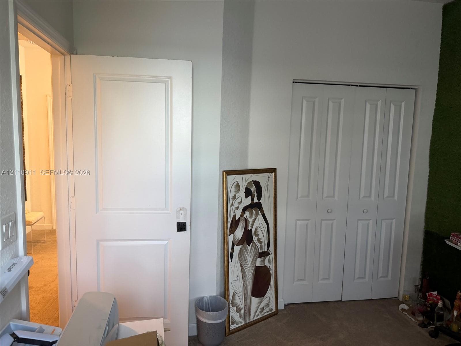Room featuring dual-tone adjustable roller shades, recessed ceiling lighting, and a glass-paneled door with exterior access