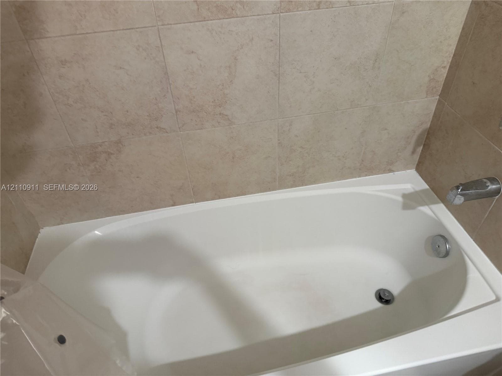 White countertop vanity with an integrated basin and a rectangular wall-mounted mirror