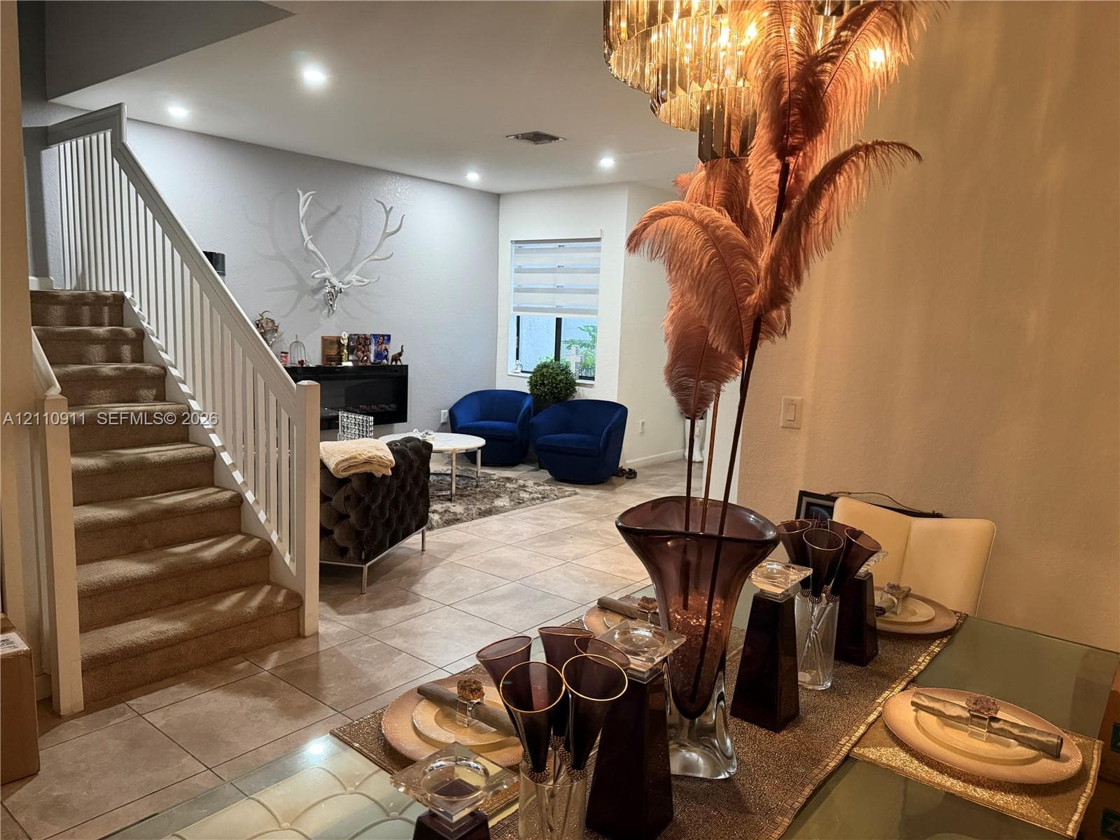 Kitchen featuring dark-finish cabinetry, stone-surface countertops, stainless steel appliances, and pendant lighting