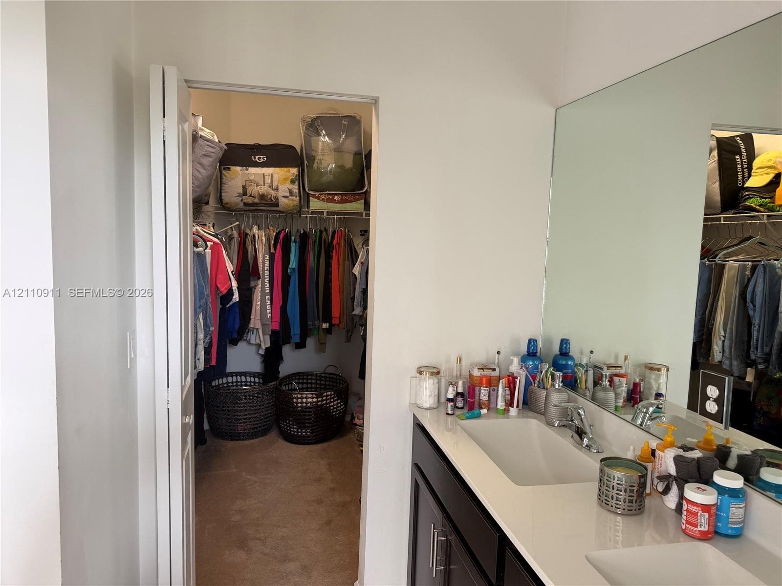 Walk-in shower enclosure featuring floor-to-ceiling tile, a chrome sliding door system, a multi-function shower head, and an integrated window
