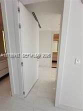 Interior featuring full-height door, neutral tile flooring, recessed ceiling lighting, and linear air distribution system