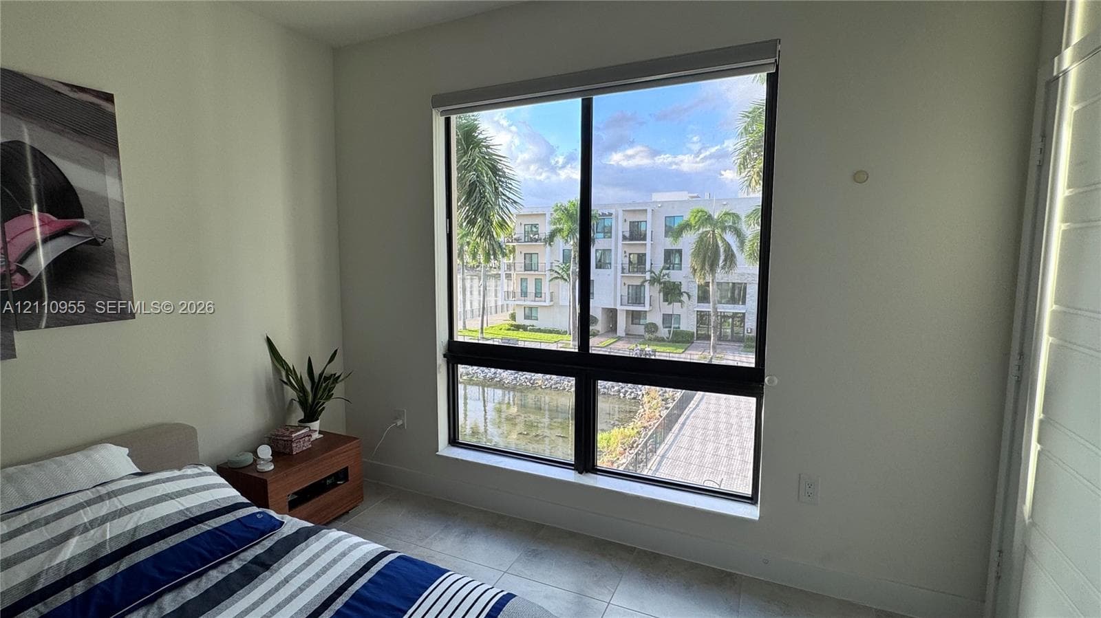 Large window with black framing and tile flooring