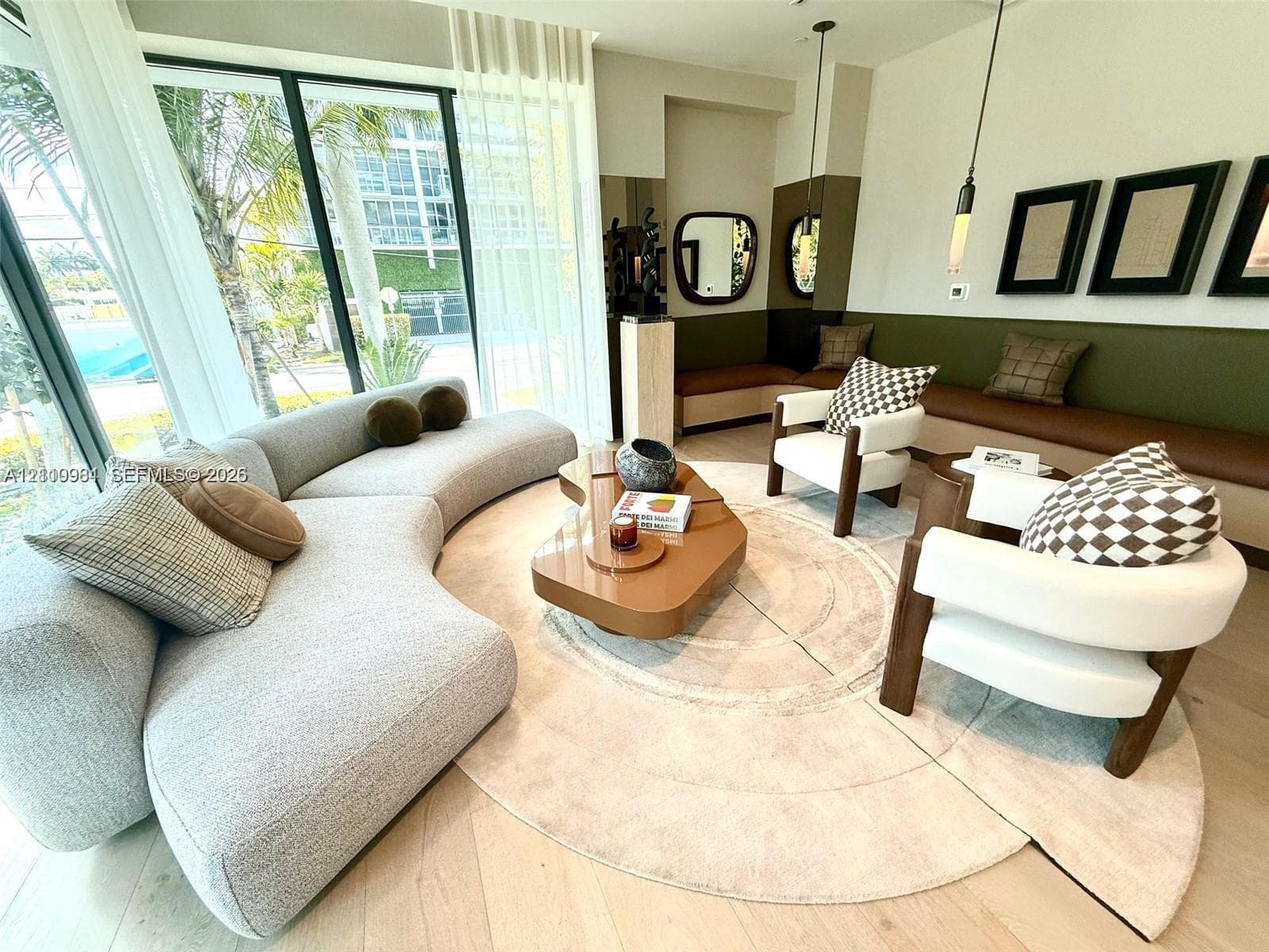 Floor-to-ceiling windows, wood-finish flooring, custom built-in bench seating, and hanging pendant lighting