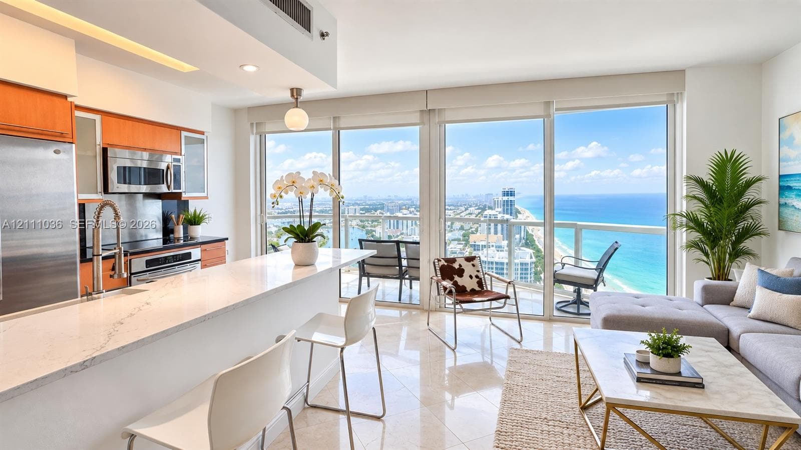 Kitchen featuring stone-surface countertops, wood-finish cabinetry, stainless steel appliances, and tile flooring, with floor-to-ceiling glass paneling and a balcony