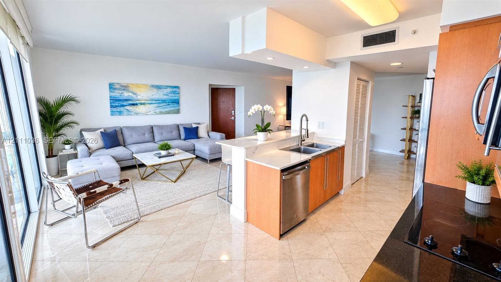 Kitchen featuring light-finish cabinetry, stone-surface countertops, dual-basin stainless steel sink with pull-down faucet, stainless steel dishwasher, and polished tile flooring