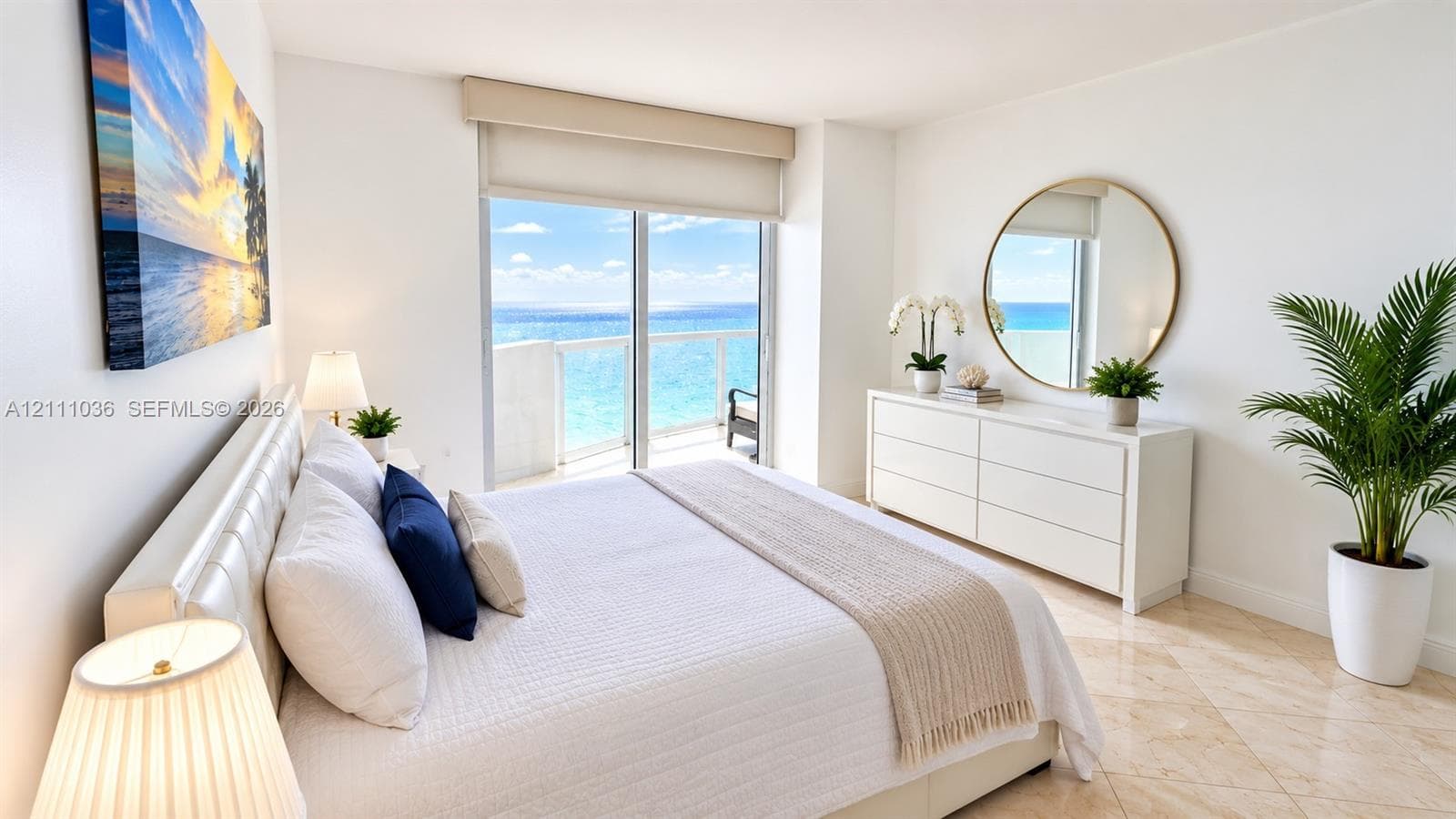 Polished stone flooring, floor-to-ceiling sliding glass doors, and a private balcony overlooking the ocean
