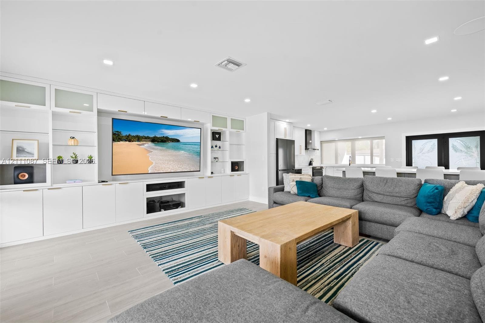 Custom floor-to-ceiling built-in cabinetry, recessed lighting, and large-format tile flooring