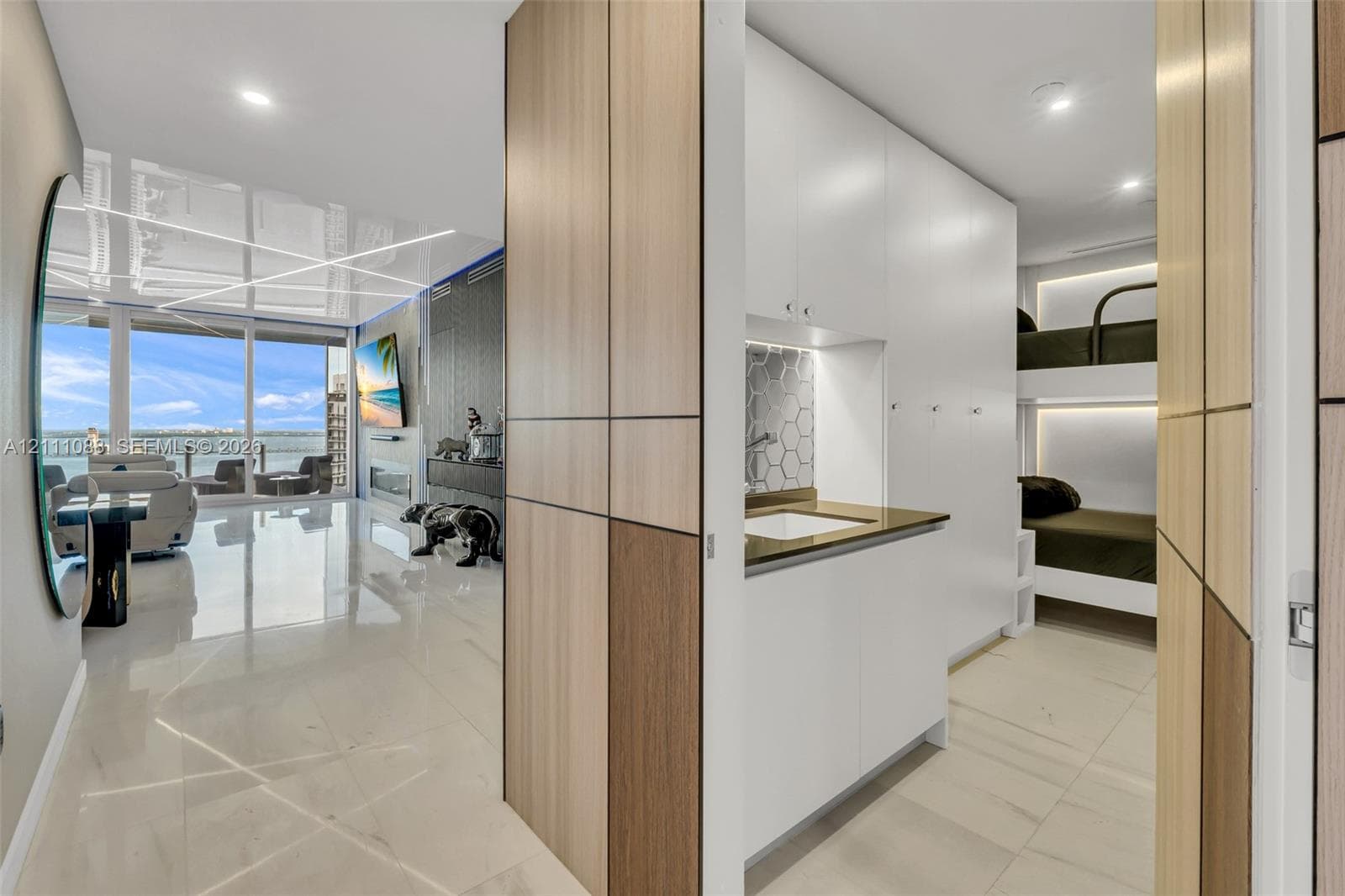 Custom cabinetry with wood-finish paneling, white flat-panel storage units, built-in wet bar with hexagonal tile backsplash, polished flooring, and floor-to-ceiling windows