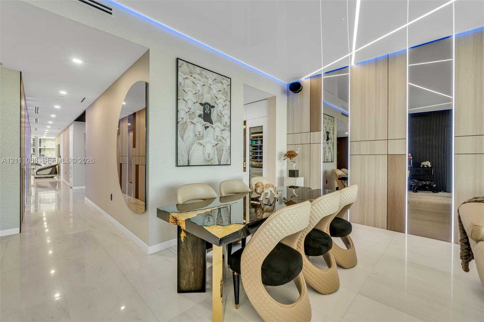 Large-format tile flooring, wood-finish paneled walls with integrated linear LED accent lighting, recessed ceiling lighting, and built-in climate-controlled wine storage