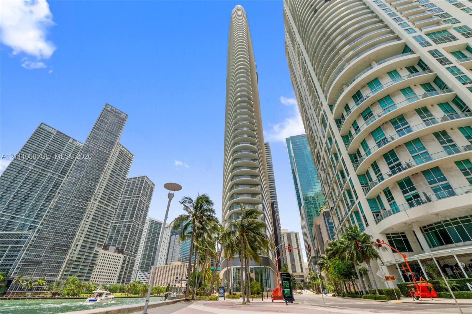 High-rise glass facade, curved balcony detailing, and structural concrete exterior elements