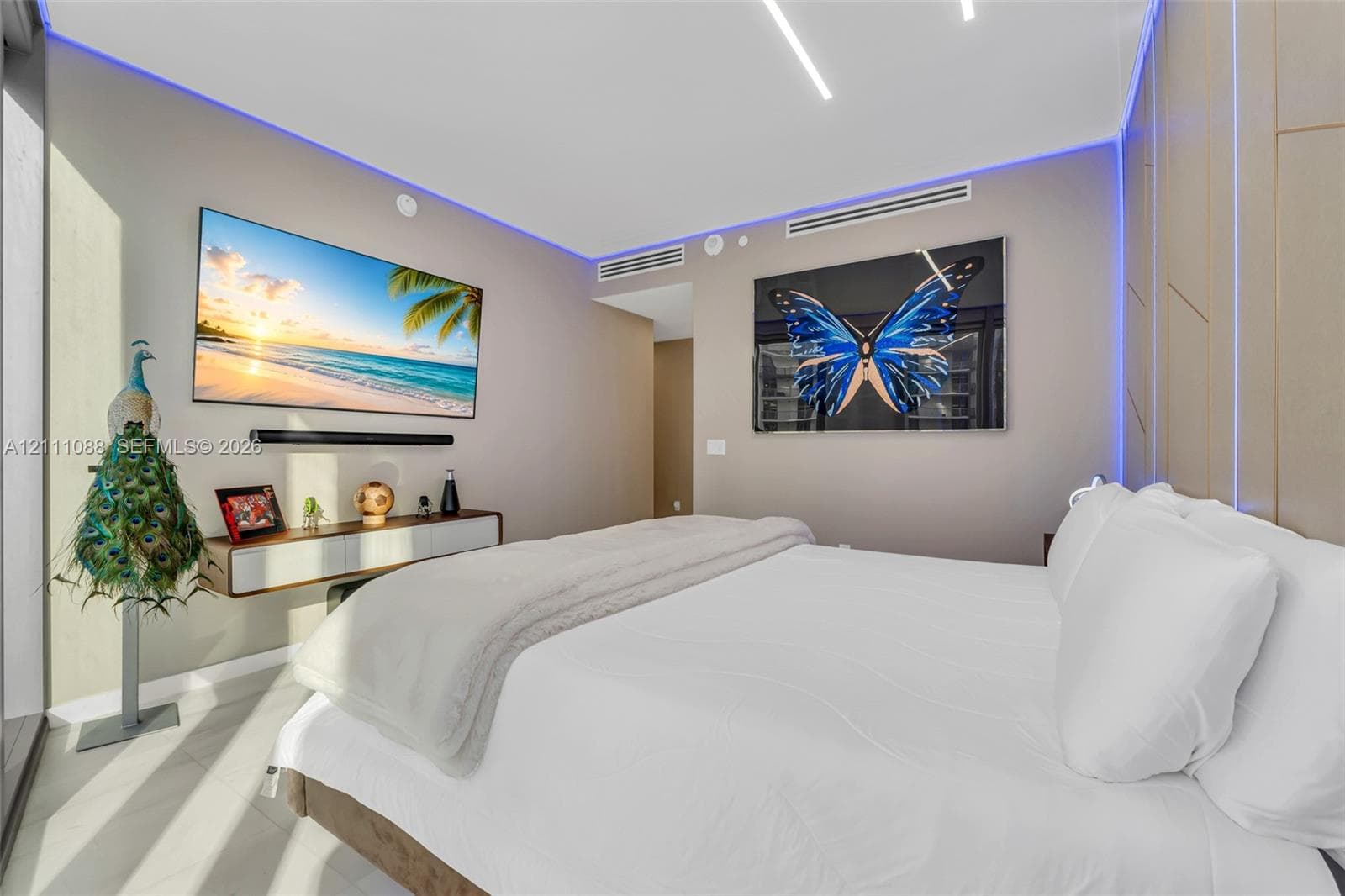 Interior space featuring recessed linear ceiling lighting, perimeter ambient cove lighting, tile flooring, and integrated wall paneling