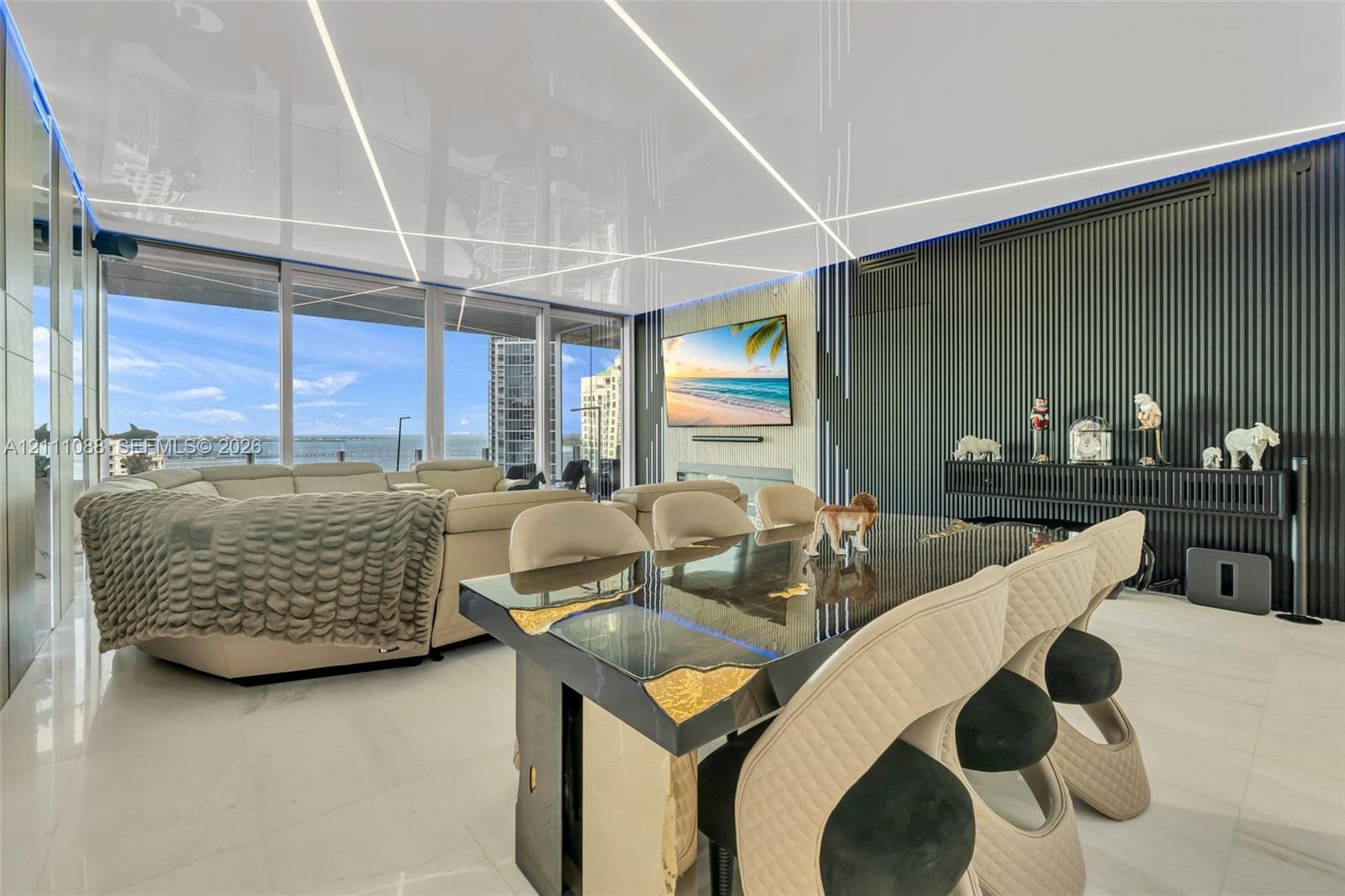 High-gloss ceiling featuring integrated linear lighting, expansive floor-to-ceiling windows, polished tile flooring, and a floor-to-ceiling fluted wall accent