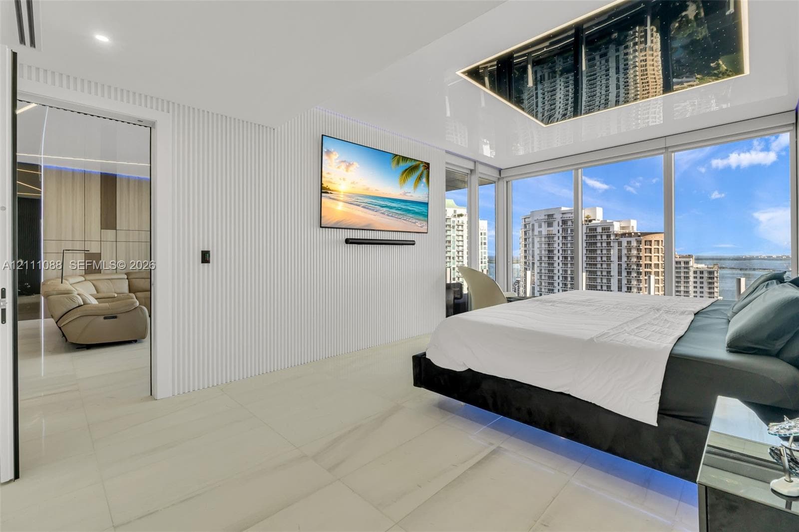 Floor-to-ceiling glass windows, high-gloss ceiling paneling, white vertical slat wall detailing, and light-toned large-format tile flooring