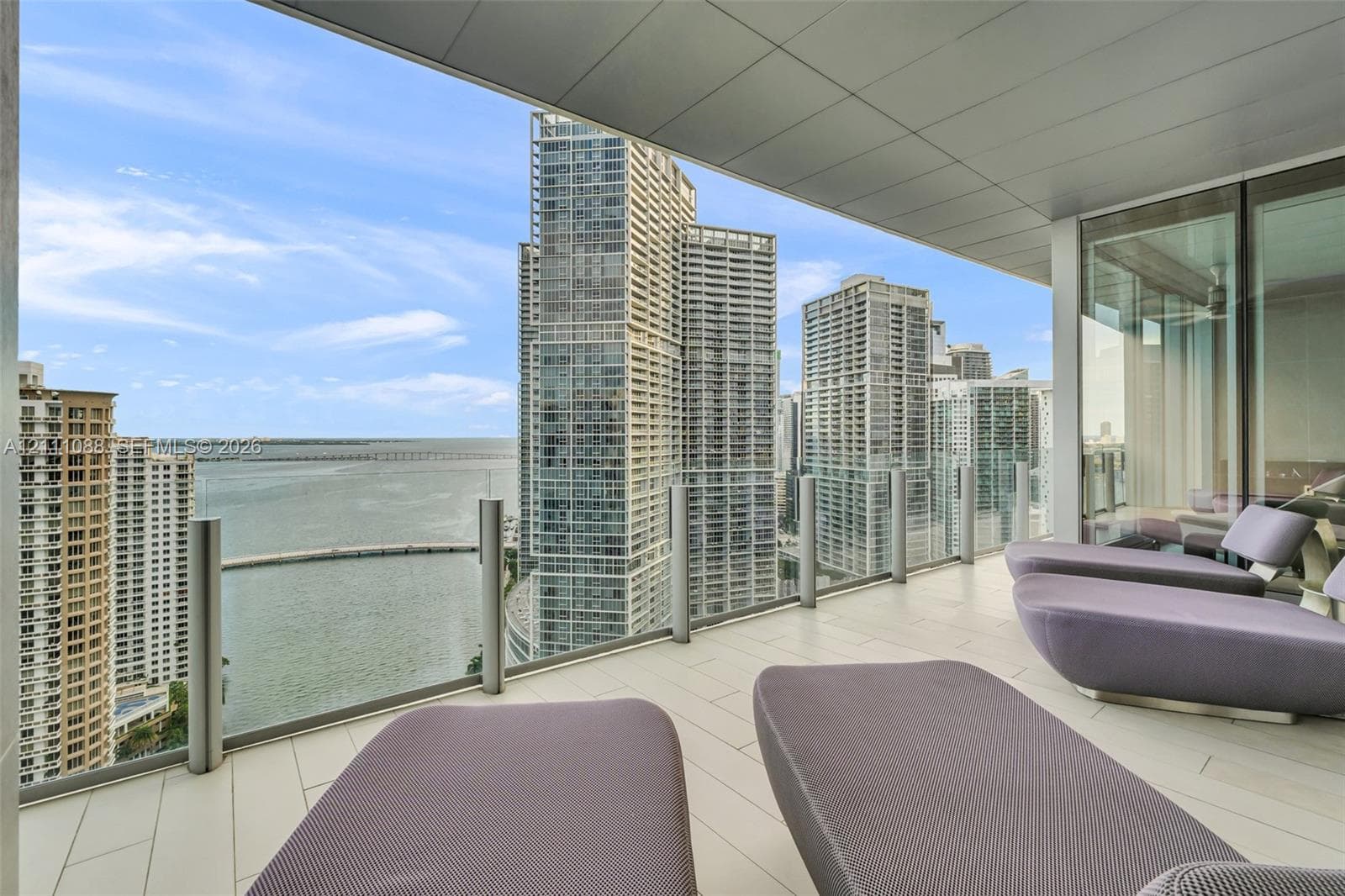 Covered terrace featuring large-format tile flooring and frameless glass balustrades