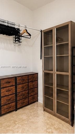 Built-in storage cabinet with glass-panel doors, integrated drawer units, and mounted hanging rod