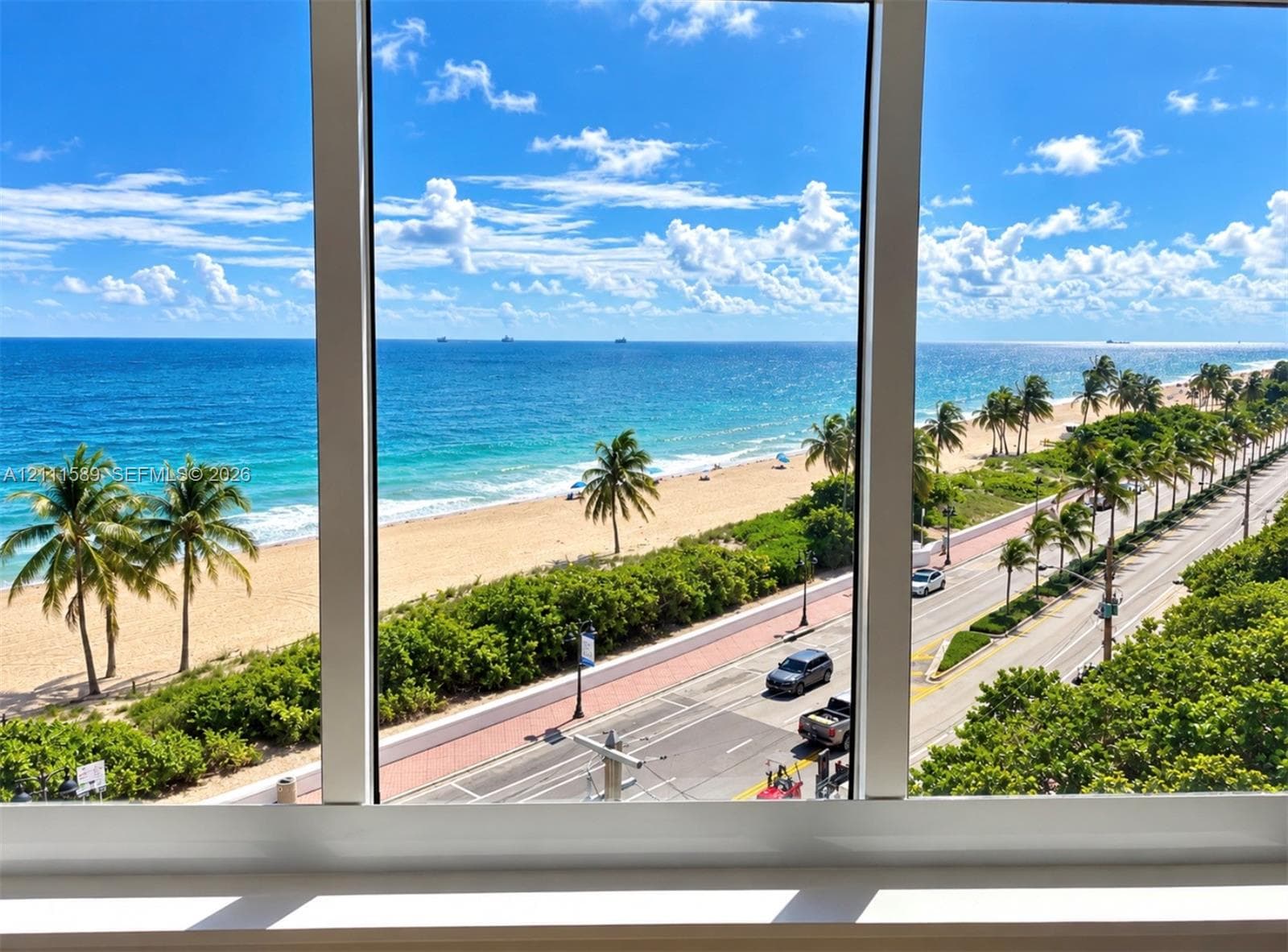 Floor-to-ceiling windows featuring panoramic ocean and coastline scenery