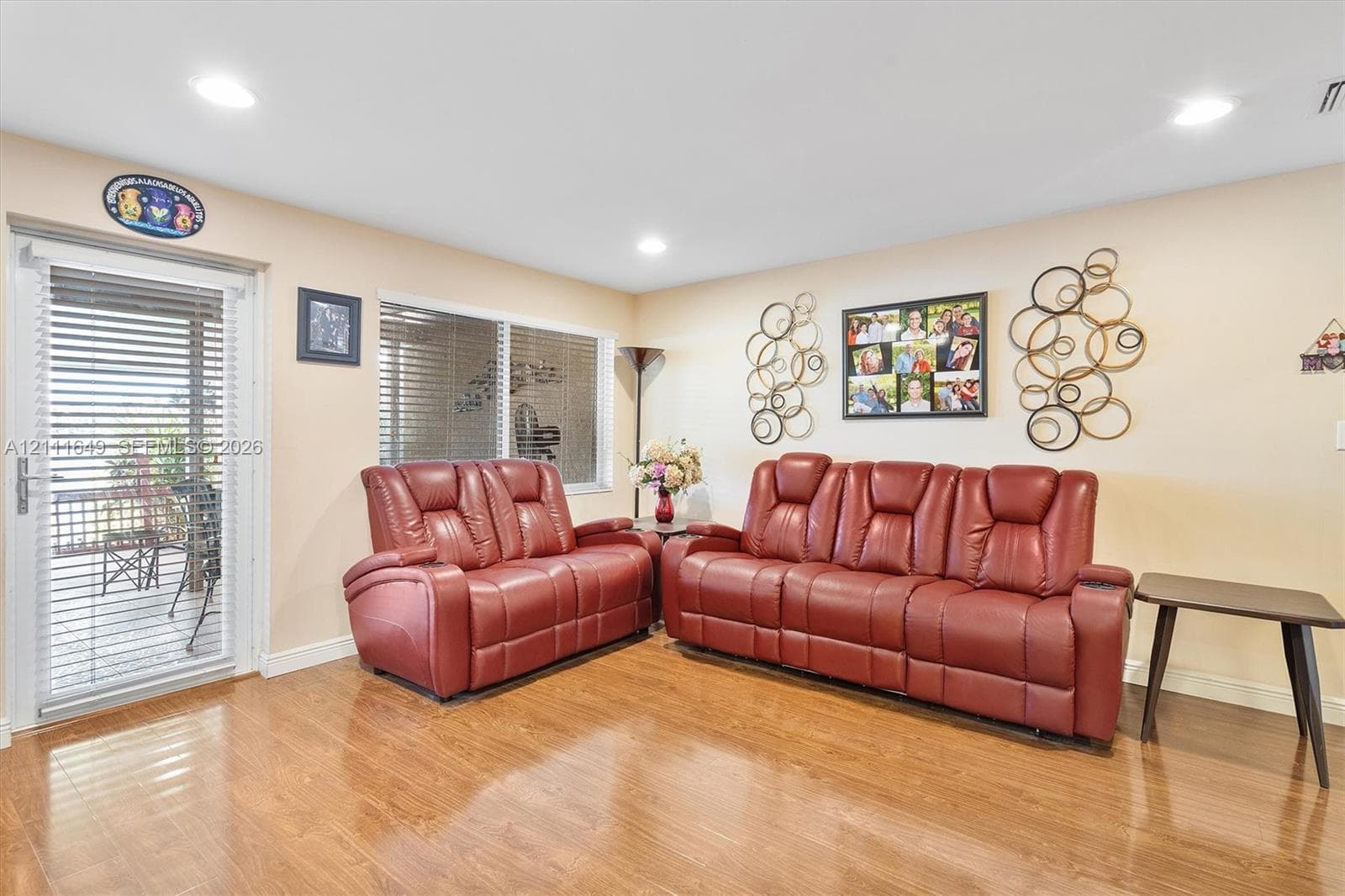 Room featuring wood-finish flooring, recessed lighting, and a glass-paneled door