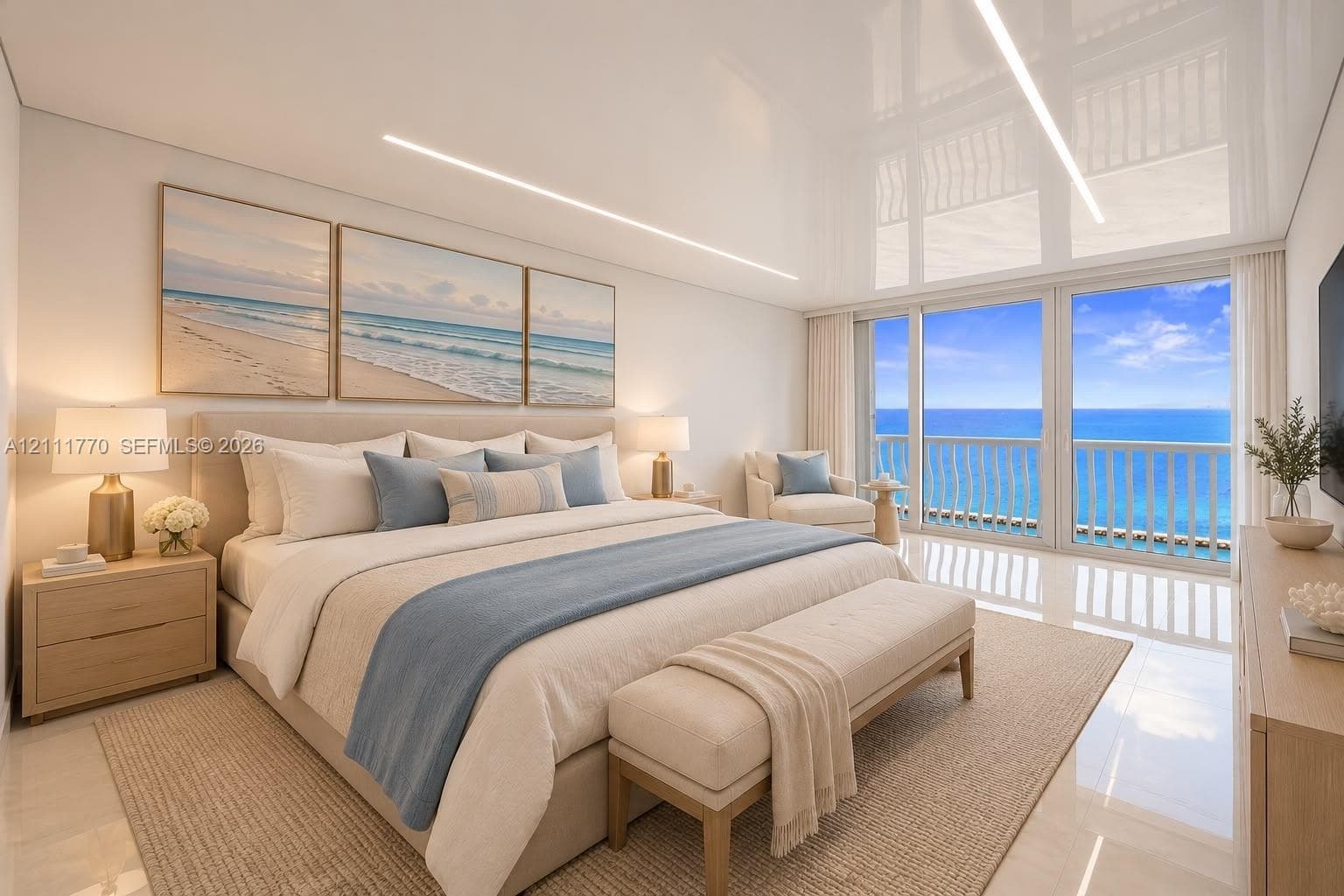High-gloss ceiling with recessed linear lighting, polished tile flooring, and large-format glass sliding doors opening to a balcony with ocean scenery