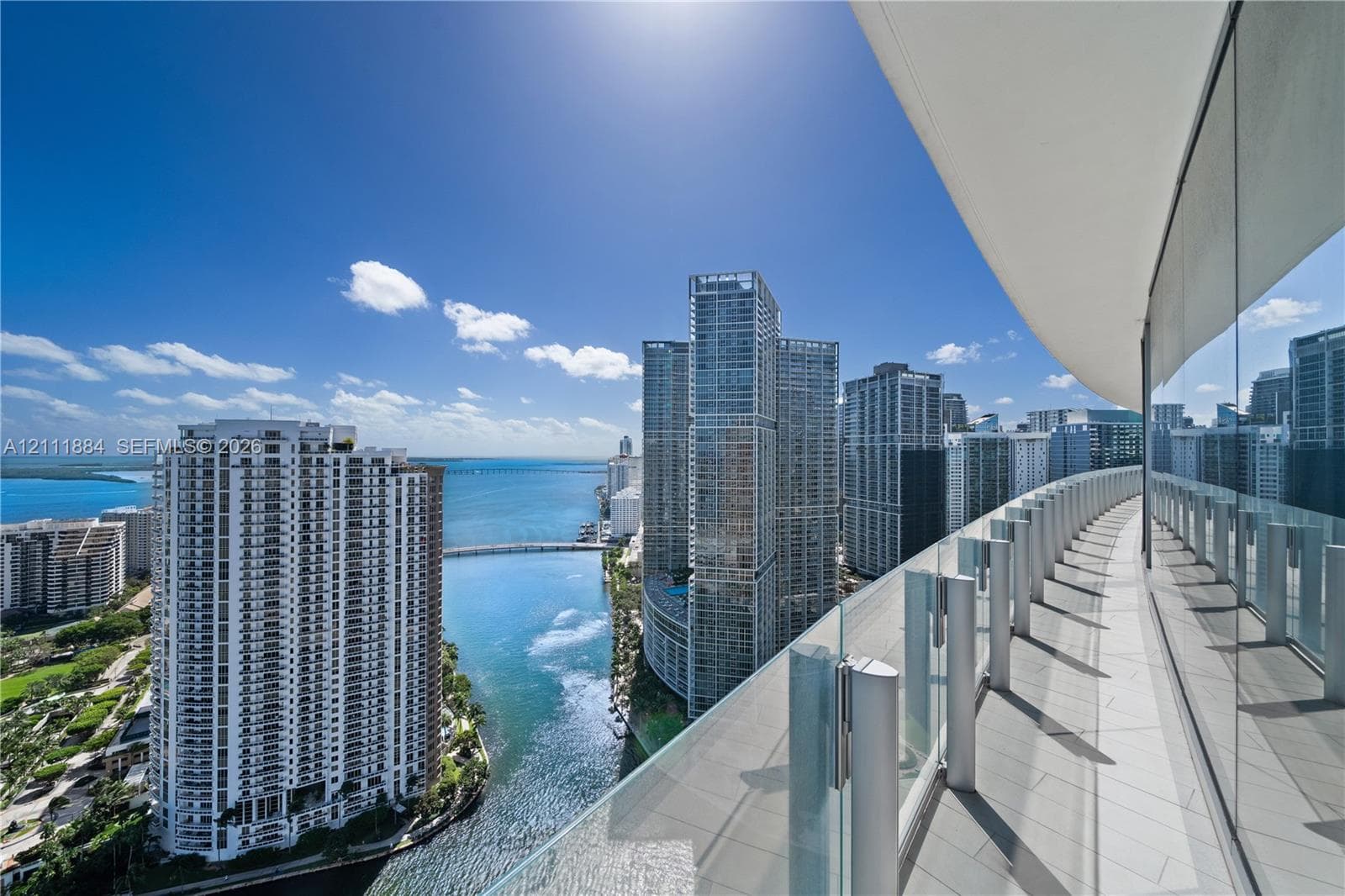 Wraparound balcony featuring large-format tile flooring and a glass panel railing