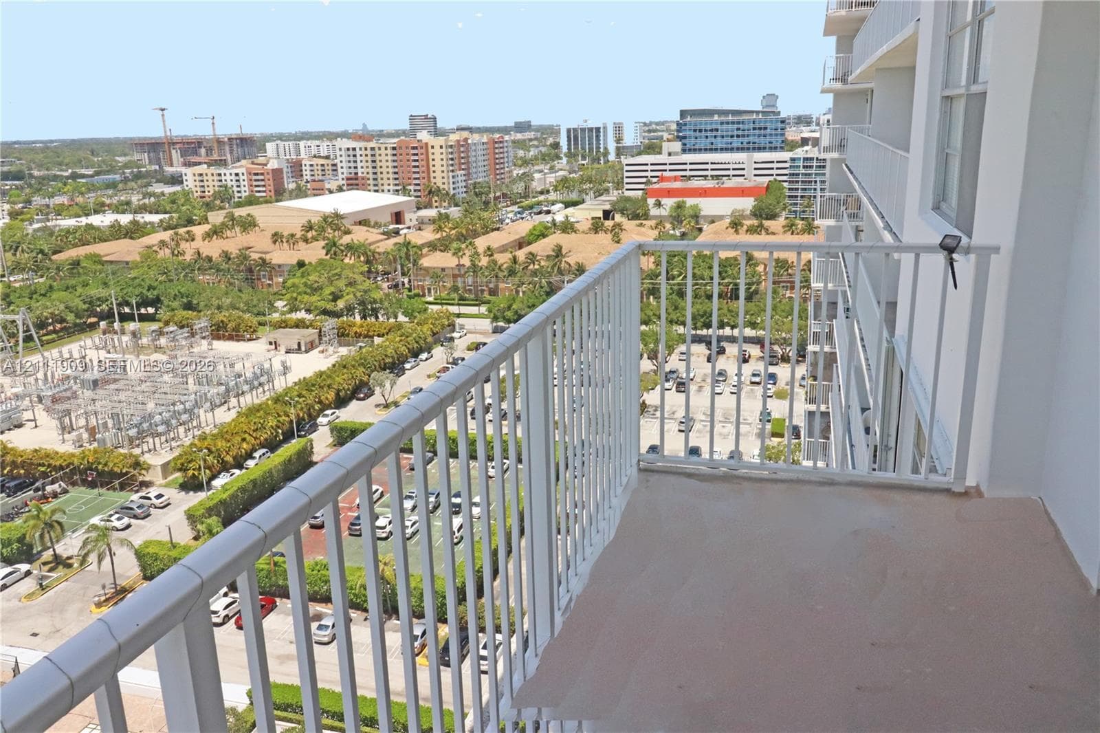 Private balcony featuring metal railings and concrete flooring