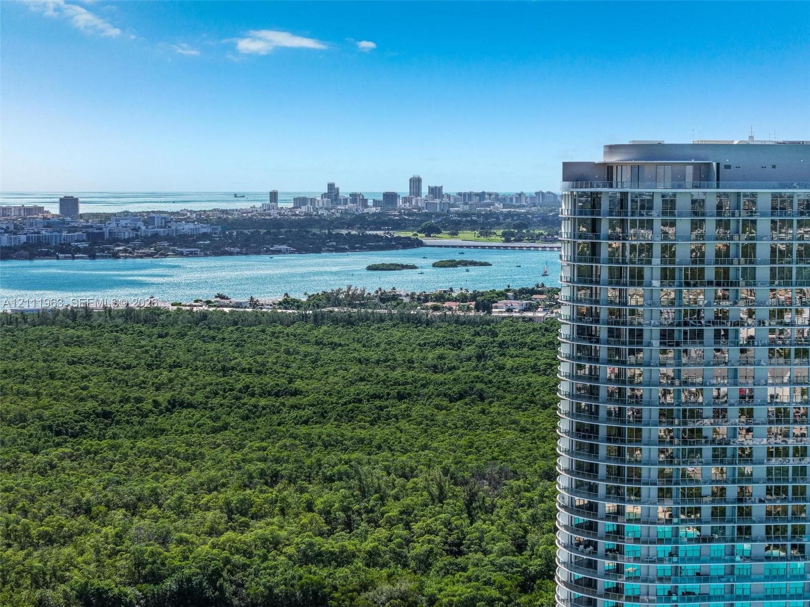 High-rise residential structure featuring floor-to-ceiling glass windows and expansive private balconies