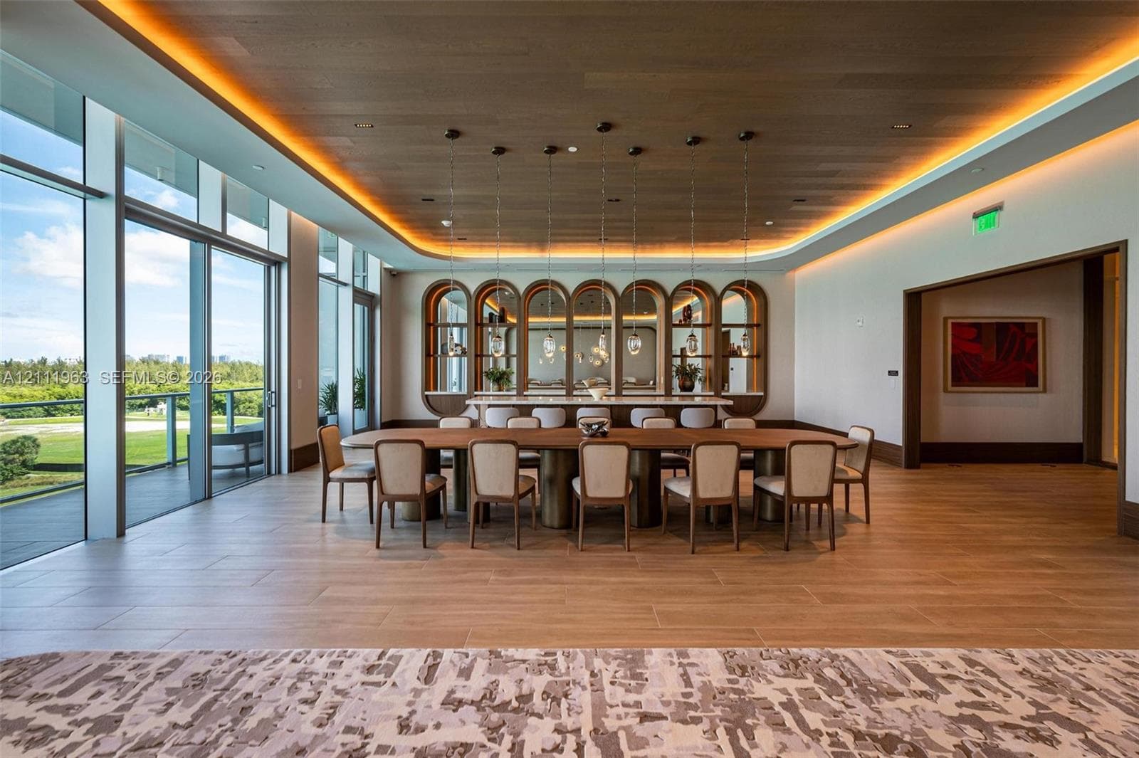 Floor-to-ceiling glass walls, wood-paneled ceiling with recessed cove lighting, built-in arched display shelving with integrated lighting, wood-finish tile flooring, and custom pendant light fixtures