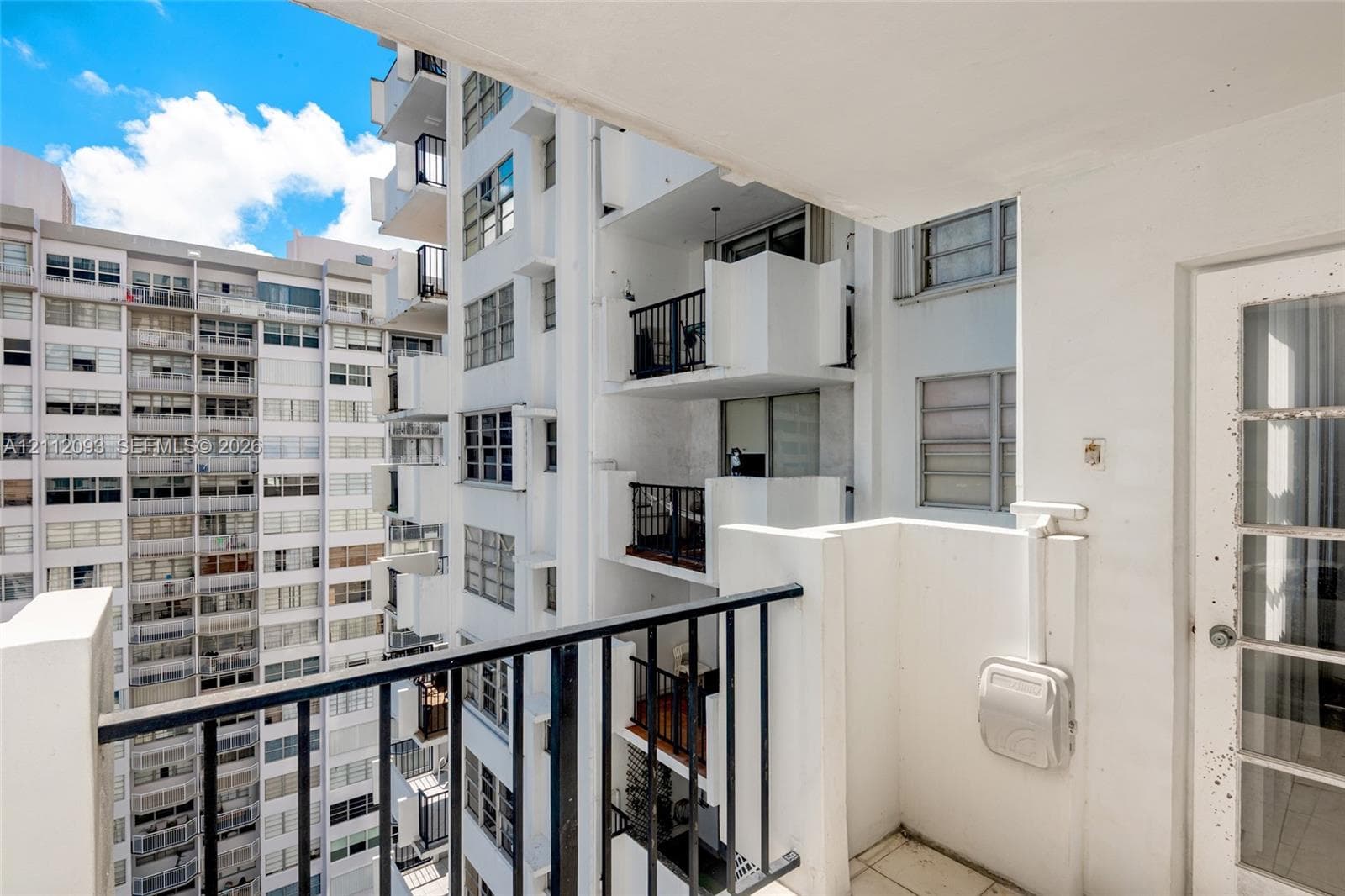 Private balcony featuring tile flooring and a metal railing