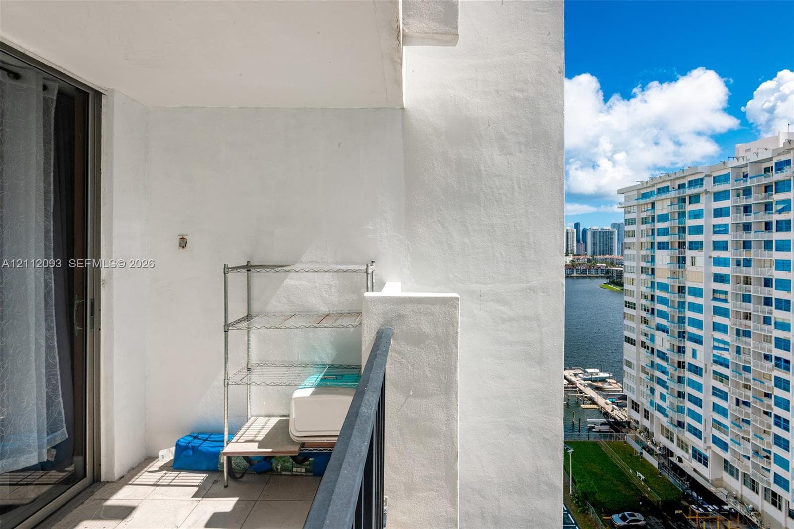 Covered balcony with a concrete floor and a metal railing