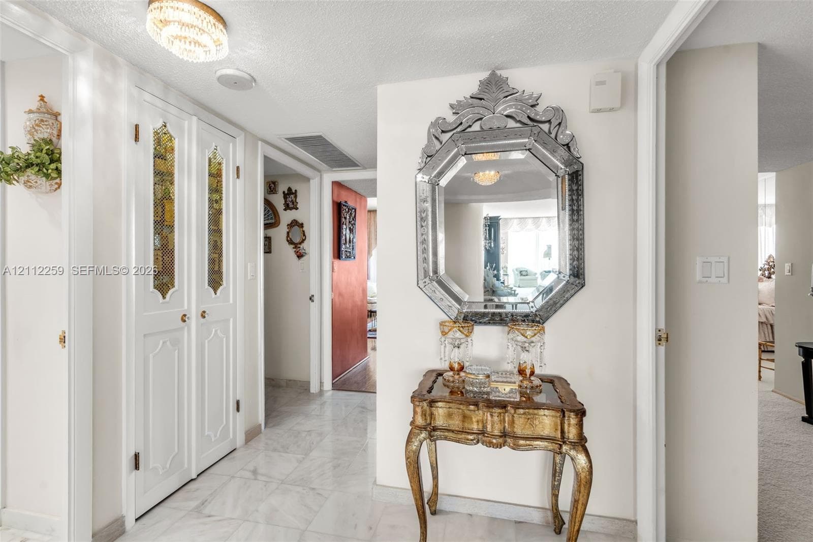 Foyer featuring stone-finish tile flooring, recessed ceiling lighting, and double-panel doors with decorative glass inserts