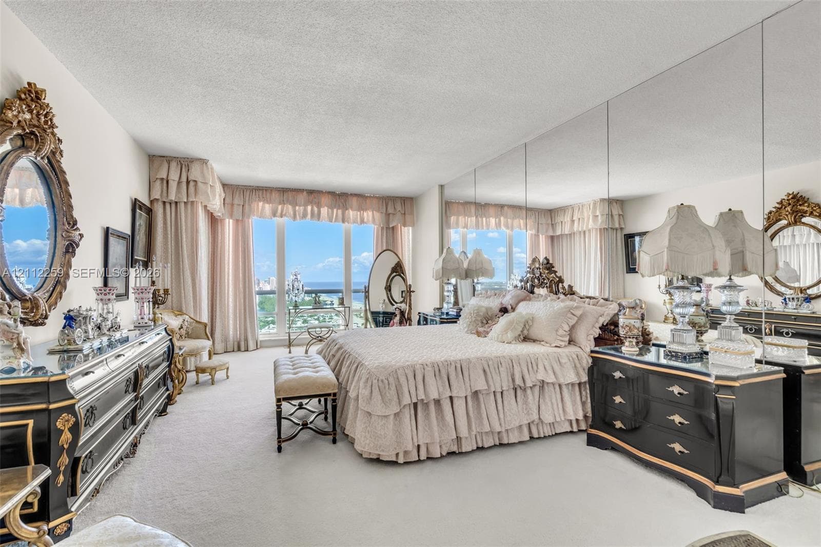 Floor-to-ceiling windows, full-wall mirrored accent, and wall-to-wall carpeting