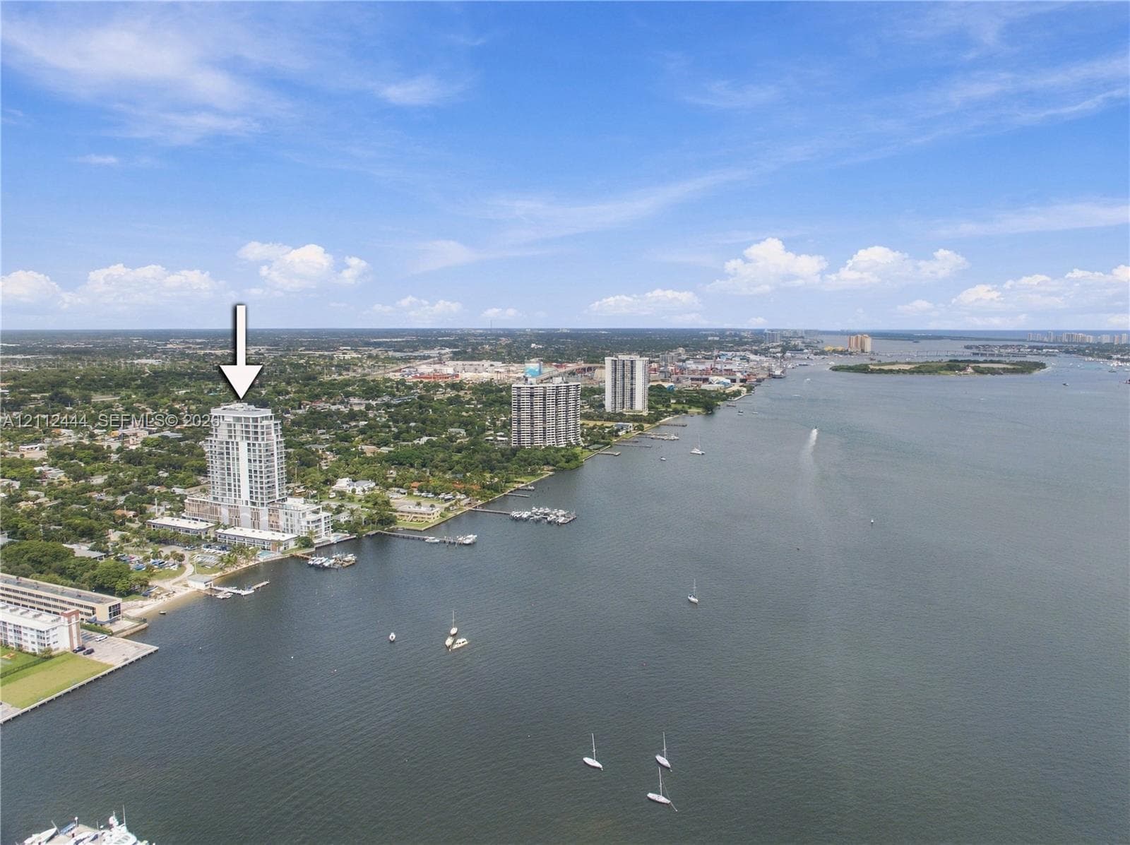 Aerial perspective of a high-rise tower featuring a waterfront location and proximity to a harbor