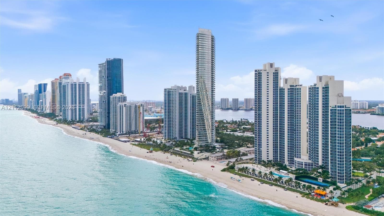 Aerial perspective of coastal high-rise development featuring direct beach access, proximity to the Atlantic Ocean, and expansive shoreline exposure