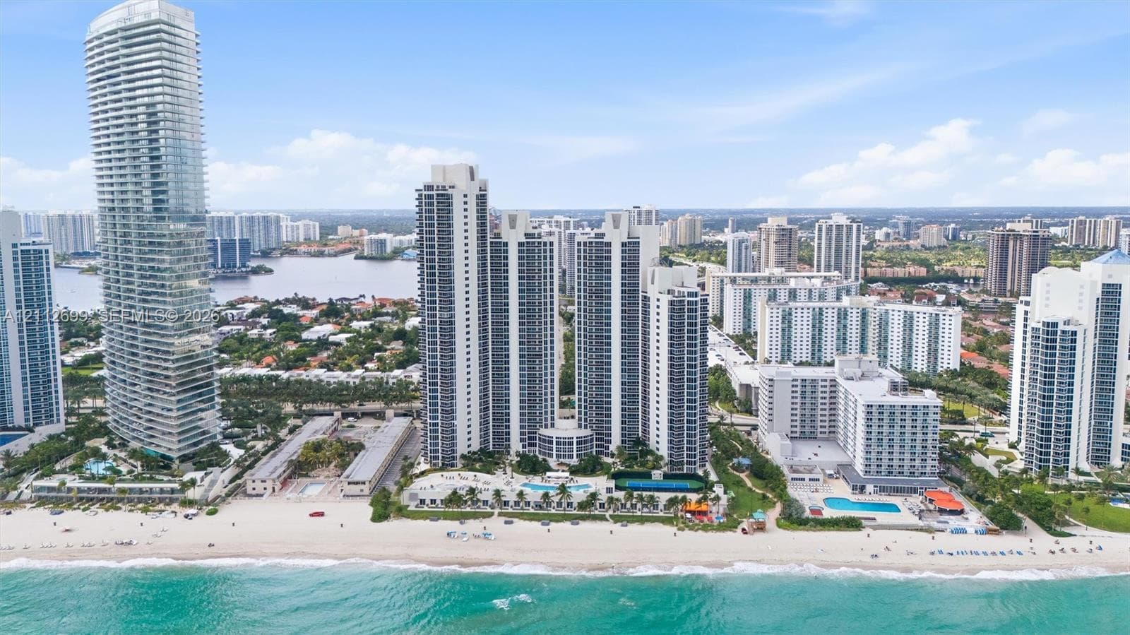 High-rise coastal towers featuring direct beach access, multiple outdoor swimming pools, expansive sun decks, and proximity to inland waterways