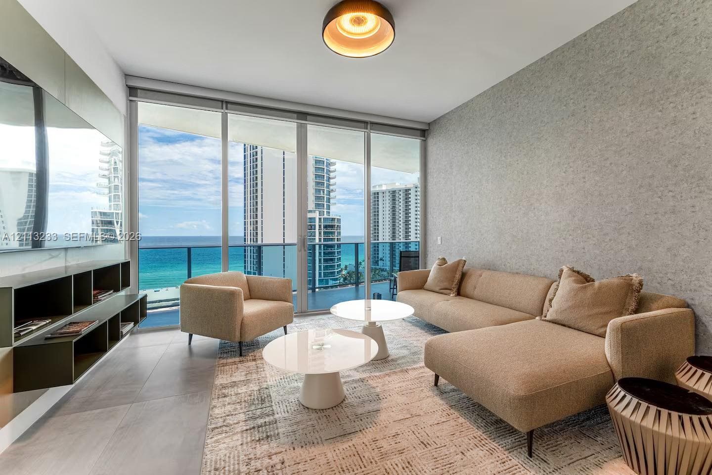 Floor-to-ceiling windows, built-in shelving, textured wall finish, tile flooring, and a glass-railing balcony