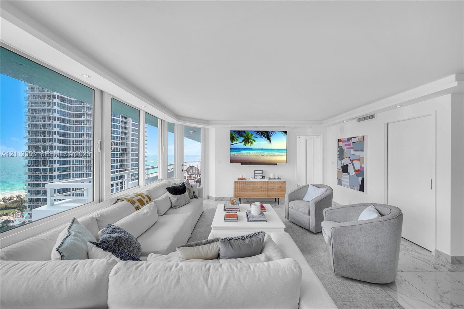 Floor-to-ceiling windows, stone-finish flooring, recessed ceiling lighting, and built-in door hardware