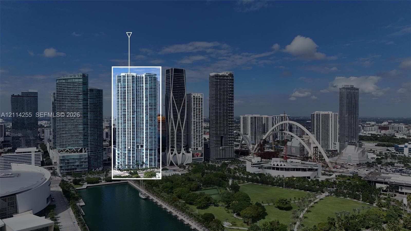 High-rise building featuring a glass facade, floor-to-ceiling windows, and private balconies