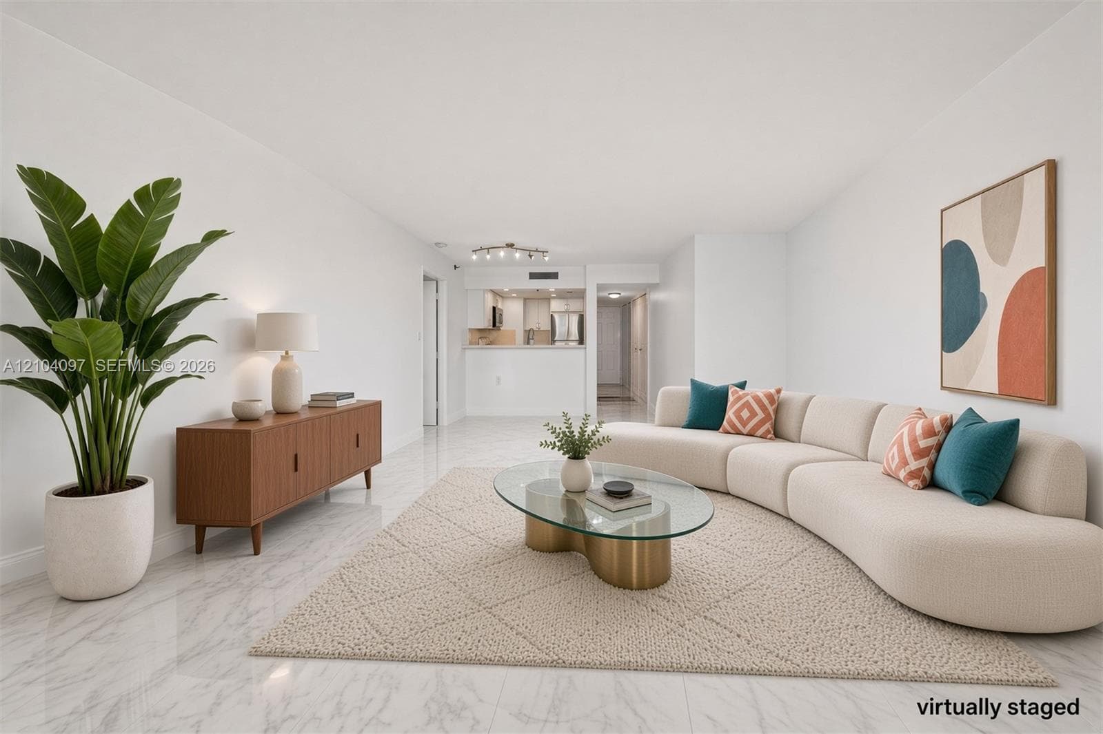 Open-concept living area featuring light-toned stone-pattern flooring, neutral wall finishes, and a breakfast bar