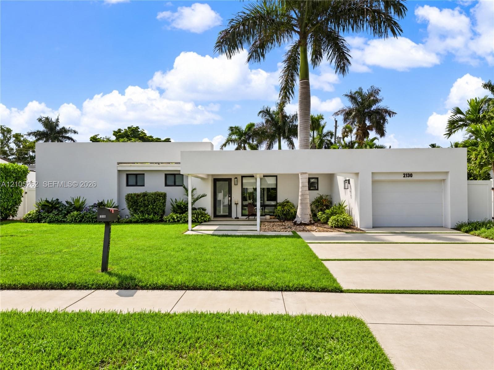 Contemporary single-story residence with a flat roofline, integrated garage, and a covered entry