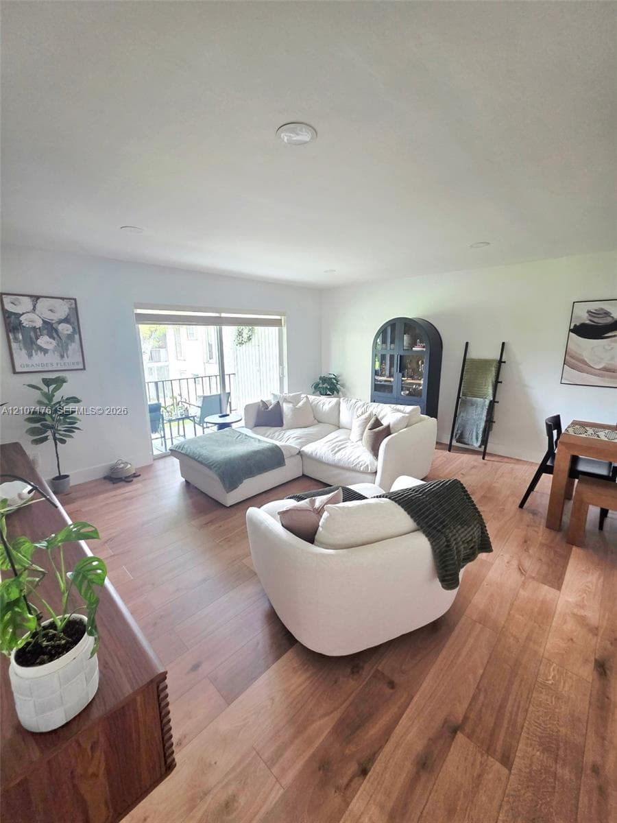 Interior space featuring wood-finish flooring, recessed lighting, and a sliding glass door providing exterior access