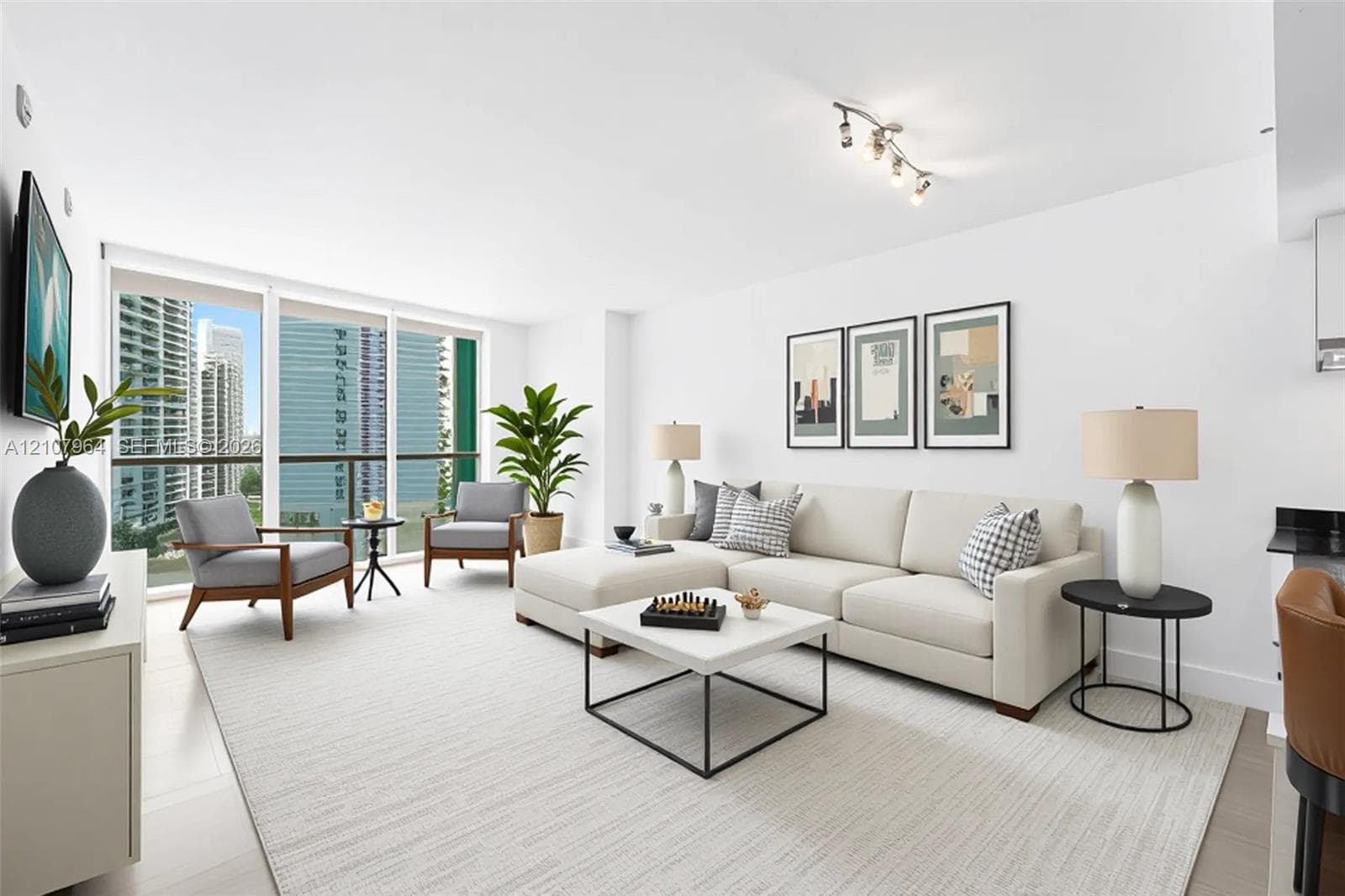 Living area featuring floor-to-ceiling windows, access to a private balcony, flooring, and multi-bulb track lighting - Virtually staged.